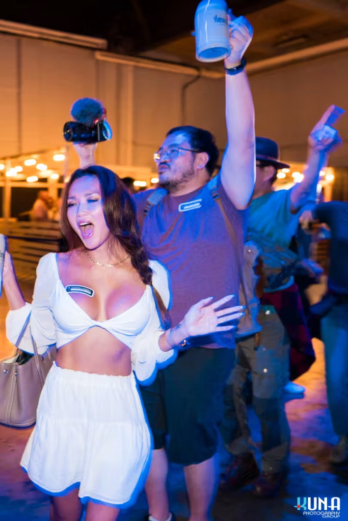 vancouver event photography - High-energy candid shot of attendees dancing and raising their beer steins during a parade at Harvest Haus.