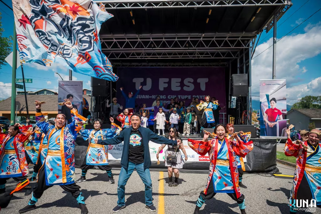 TJ Fest 2025 Kuna Photography: Vancouver Event Photographer. Performers and MC Jerry Liu waving flags during the TJ Fest grand finale in Burnaby, BC.