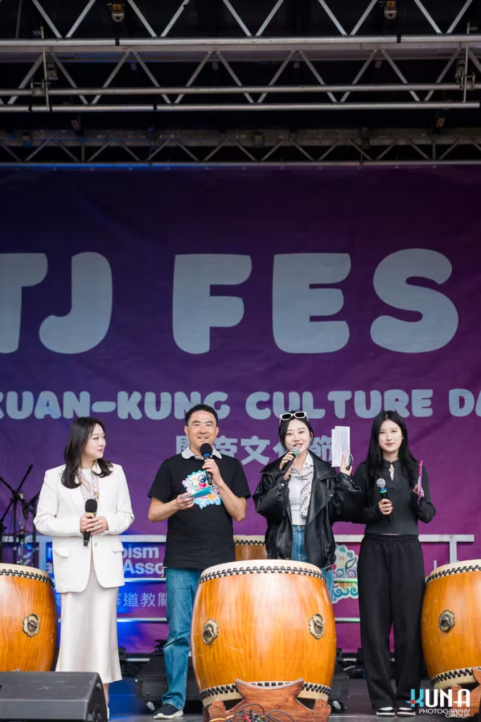 Kuna Photography: Vancouver Event Photographer. Event MCs speaking on stage in front of large ceremonial drums during Kuan-Kung Culture Days in BC.