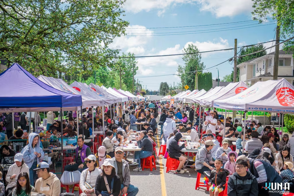 Kuna Photography: Vancouver Event Photographer. High-angle view of the crowded TJ Fest on Smith Avenue with vendor booths & outdoor dining in BC.