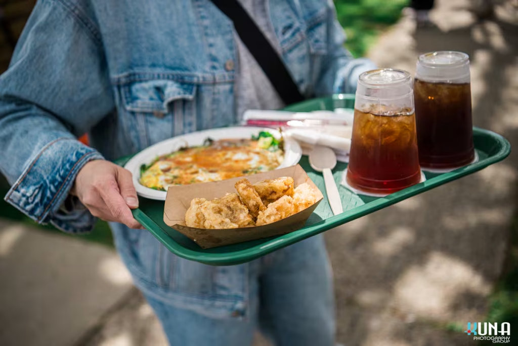 TJ Fest 2025 Kuna Photography: Vancouver Event Photographer. Authentic Taiwanese street food tray with oyster omelette and iced tea at TJ Fest in Burnaby, BC.