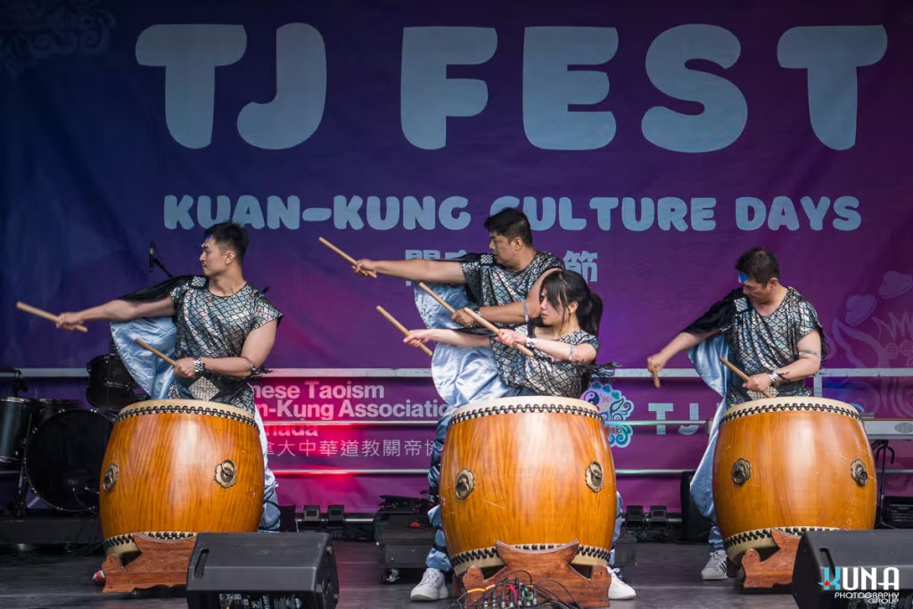 TJ Fest 2025 una Photography: Vancouver Event Photographer. Drummers in silver scale-patterned vests performing a synchronized routine on the TJ Fest stage in BC.