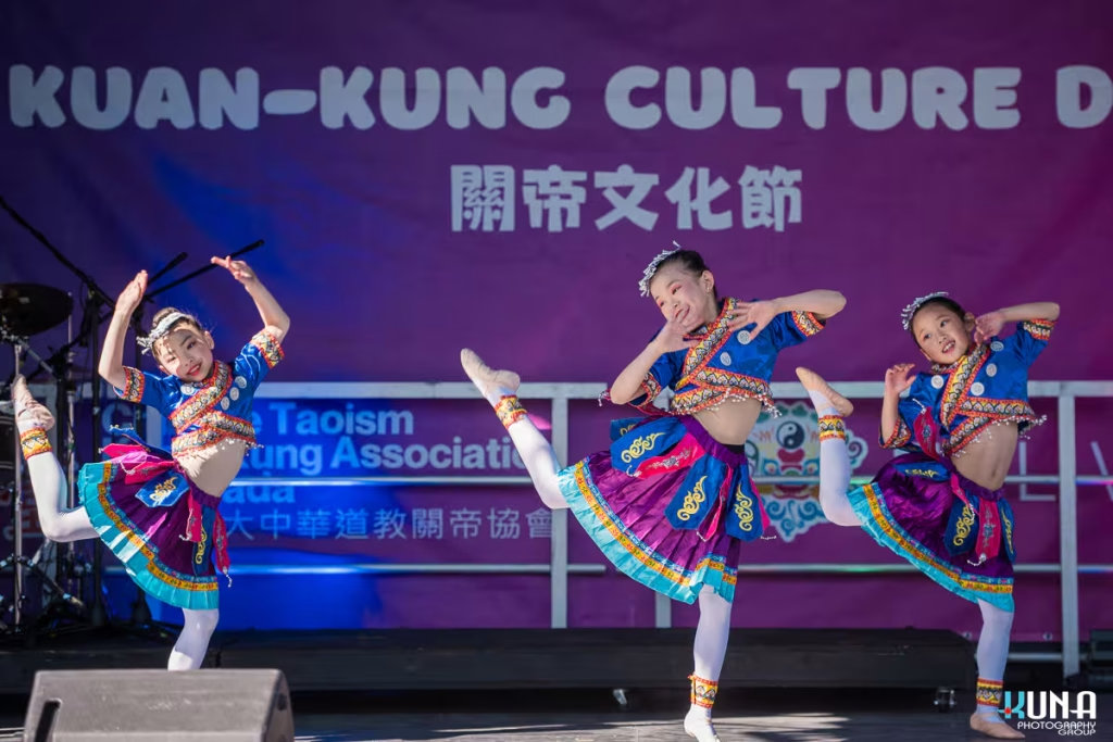 TJ Fest 2025 Kuna Photography: Vancouver Event Photographer. Three girls in blue and purple traditional Chinese dance costumes performing on the TJ Fest stage in BC.