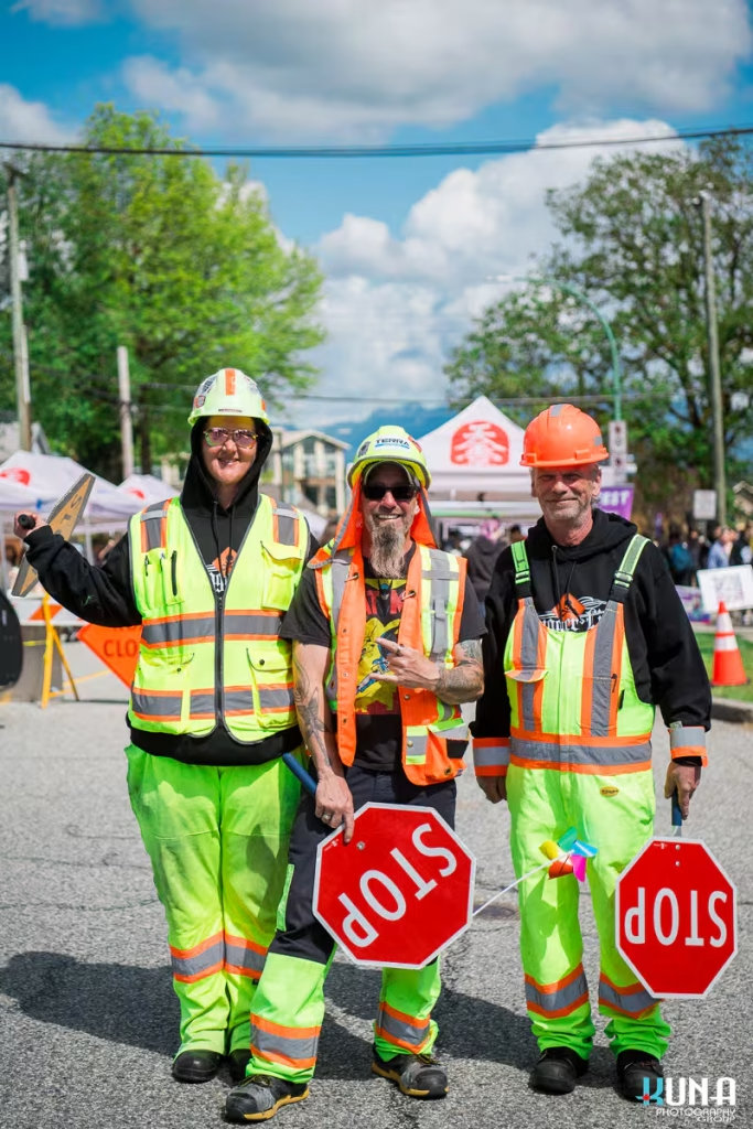 Kuna Photography: Vancouver Event Photographer. Three traffic management staff in safety gear at the TJ Fest street closure in Burnaby, BC.