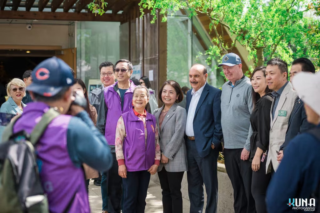 A candid moment of VIP guests and organizers smiling together outside the temple doors, part of our comprehensive TJ Fest event photography coverage.