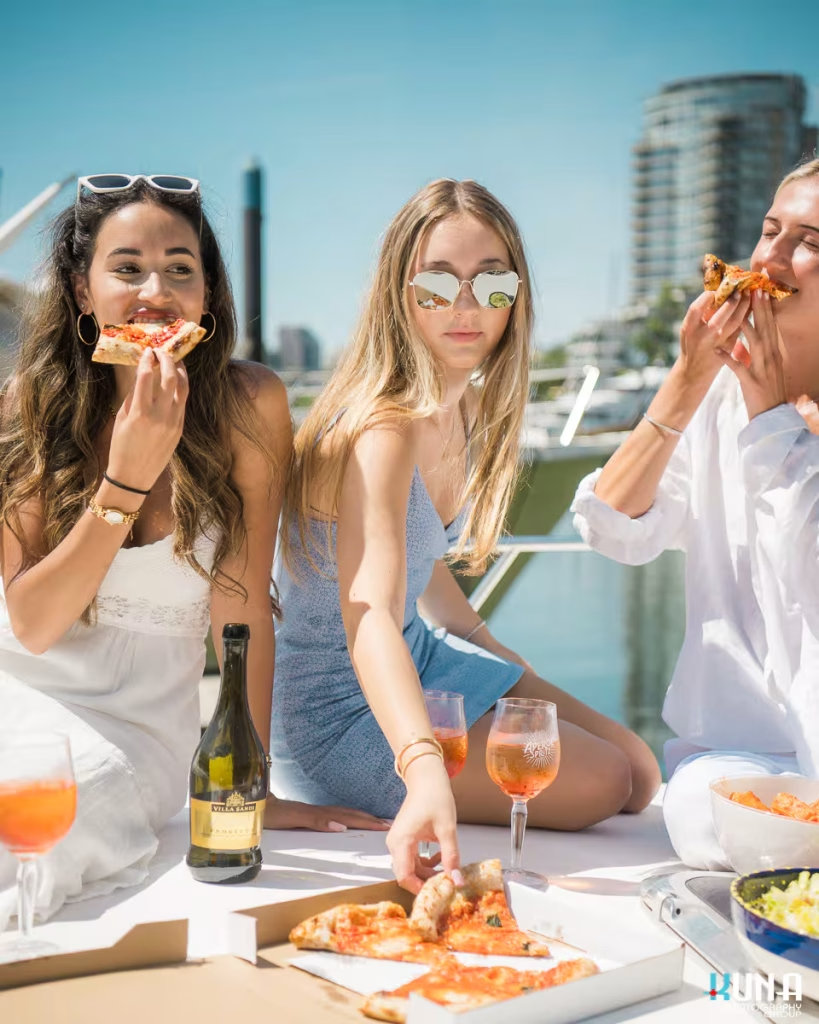 Eating pizza on a yacht for Capo and the Spritz. Captured by commercial photographer Kuna Photography.