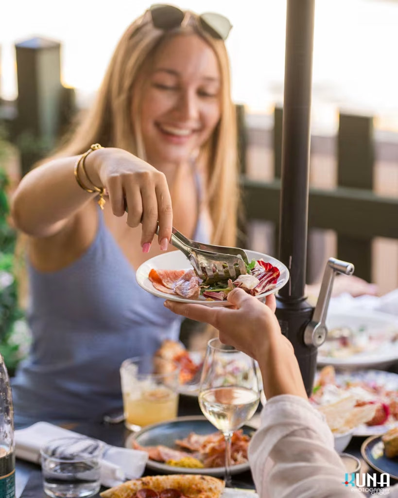 Sharing appetizers at Capo and the Spritz. Captured by commercial photographer Kuna Photography.