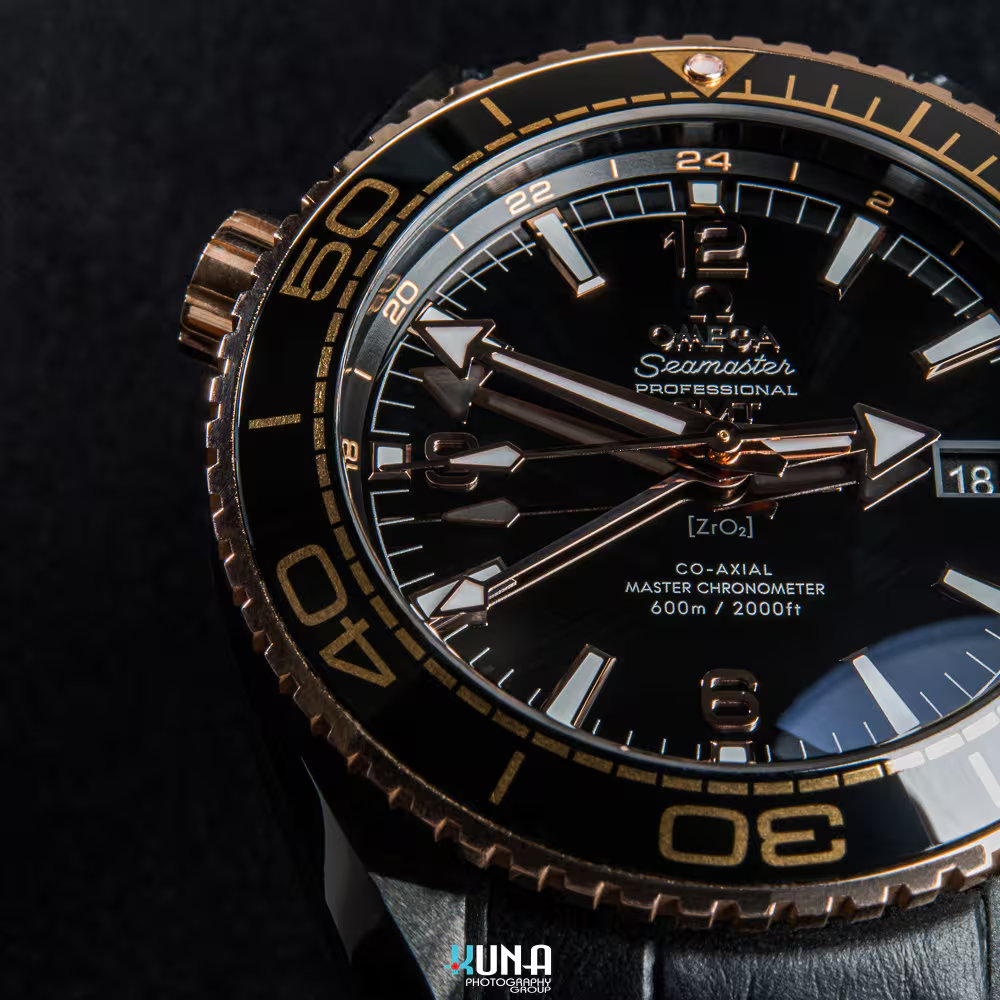 Kuna Photography - Macro Detail: Omega GMT Hand & Dial Kuna Photography commercial product photographer macro dial detail showing ZrO2 ceramic engraving and GMT hands on Omega Seamaster.