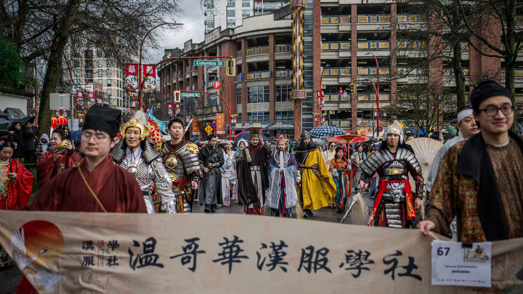 Vancouver Lunar New Year Parade 2026 - A wide shot of the grand Vancouver Hanfu Culture Association group marching together in various traditional outfits and armors.