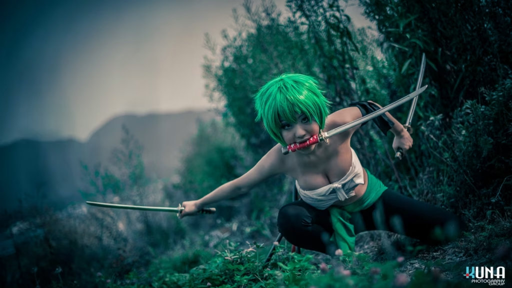 Female Zoro cosplayer Roronoa Zoro dynamic pose in misty grassy field, shot by Vancouver Cosplay Photographer Kuna Photography