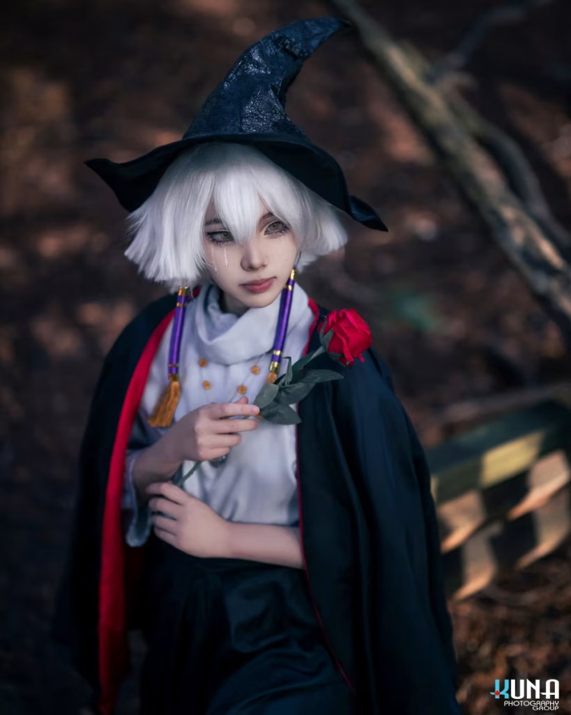 Solo portrait of a Sky: Children of the Light cosplayer wearing a witch hat and holding a red rose, by a Vancouver cosplay photographer.