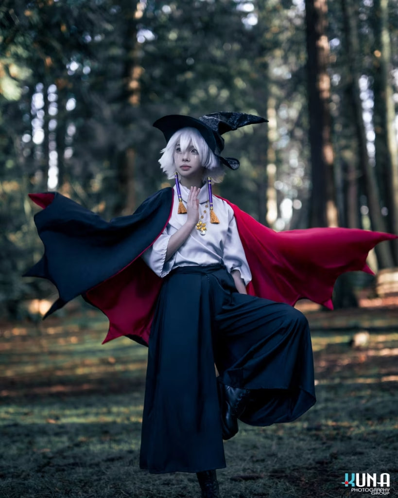 Vancouver cosplay photographer capturing a magical solo portrait of a Sky: Children of the Light cosplay with a witch hat and flowing cape in a forest.