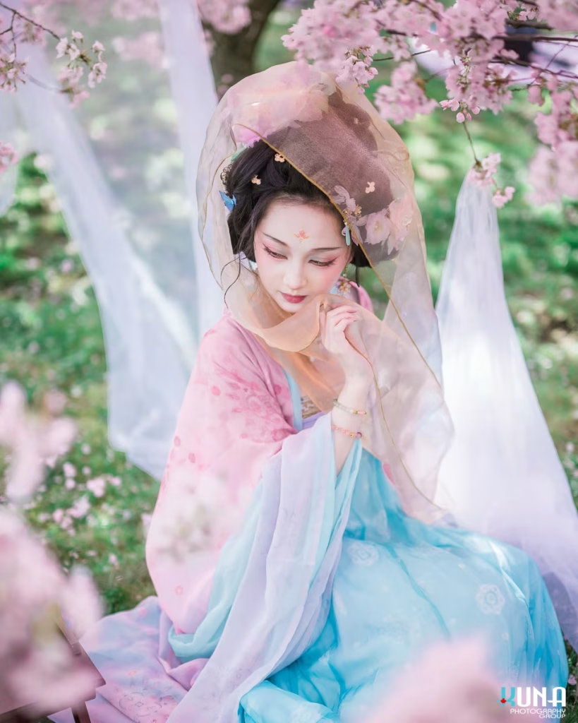 Elegant portrait featuring a golden sheer veil and intricate floral hairpins.