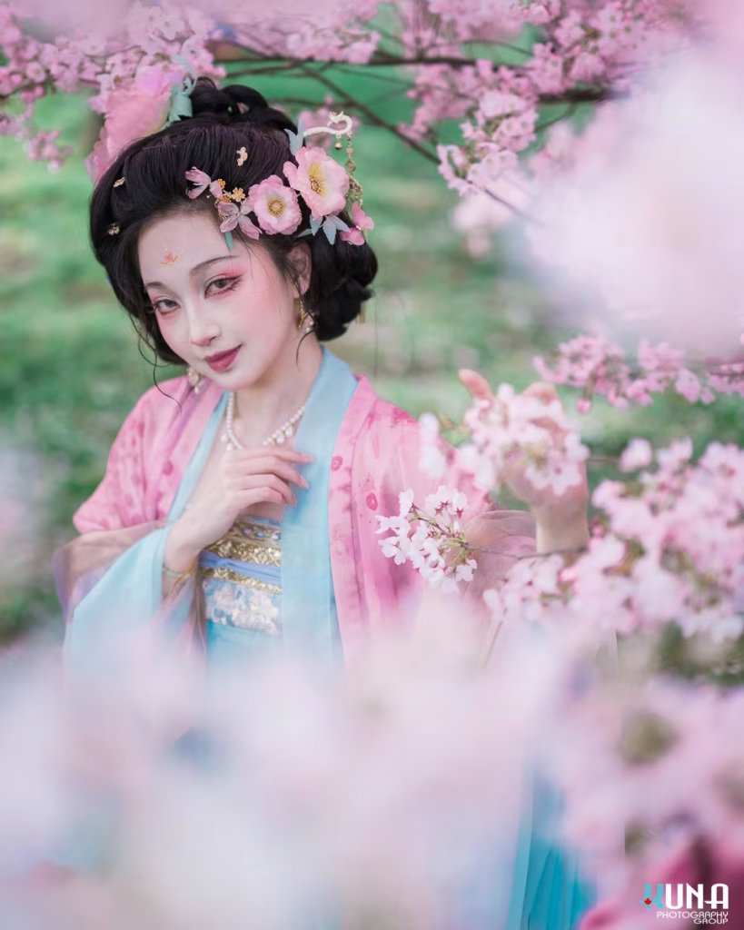 Vancouver Hanfu portrait of a lady gently holding a cherry blossom branch.