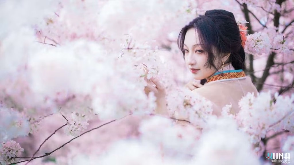 Dreamlike hanfu portrait detail in Richmond: Model integrated into massive bokeh of pink cherry blossoms at Larry Berg Flight Path Park Vancouver.