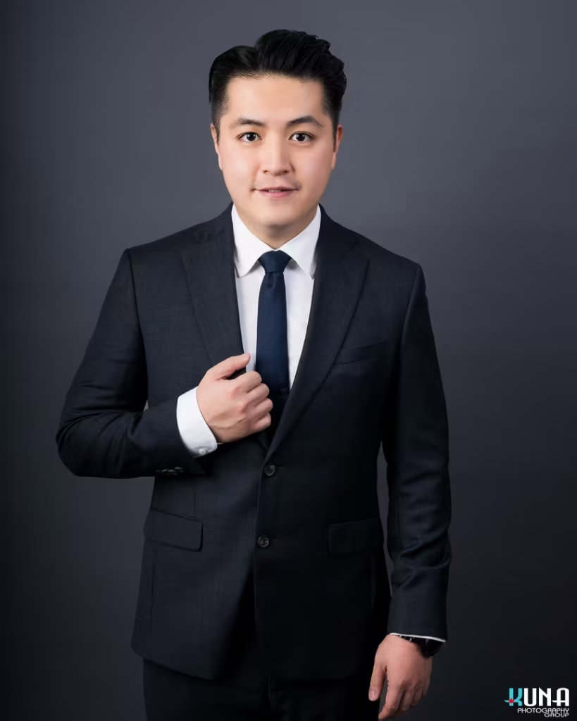 Dynamic corporate board member headshot of a young male TCCBC director in a dark suit in Vancouver British Columbia