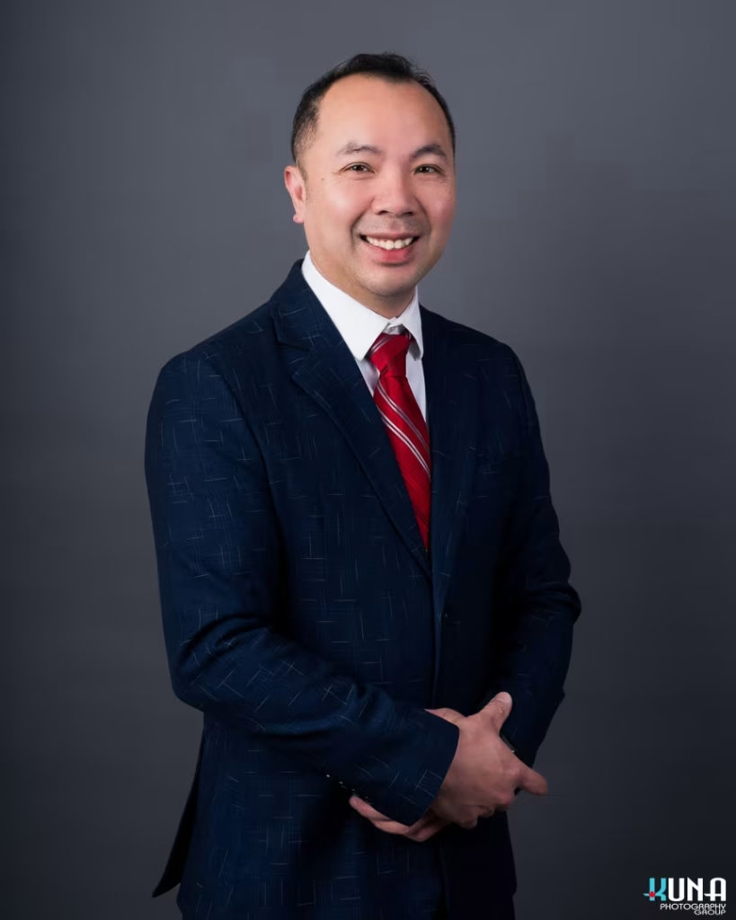 Executive corporate board member headshot of a male TCCBC presdient in a blue suit and red tie in Vancouver British Columbia