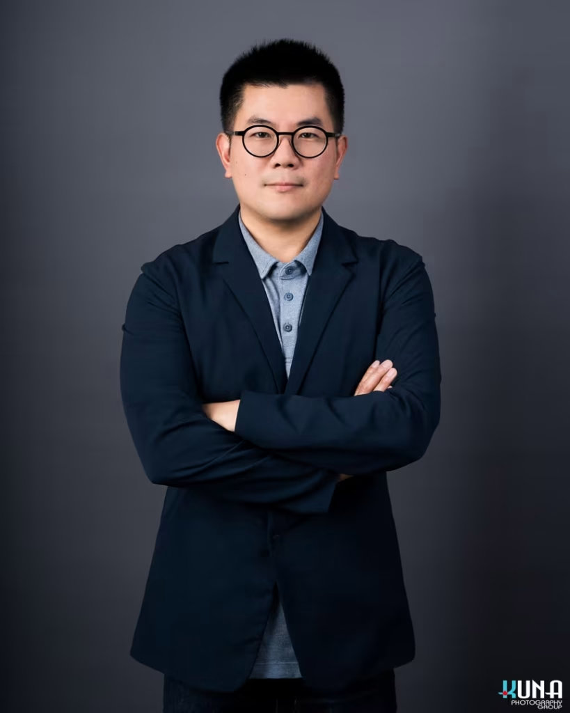 Intellectual professional board member headshot of a male TCCBC director with round glasses in Vancouver British Columbia