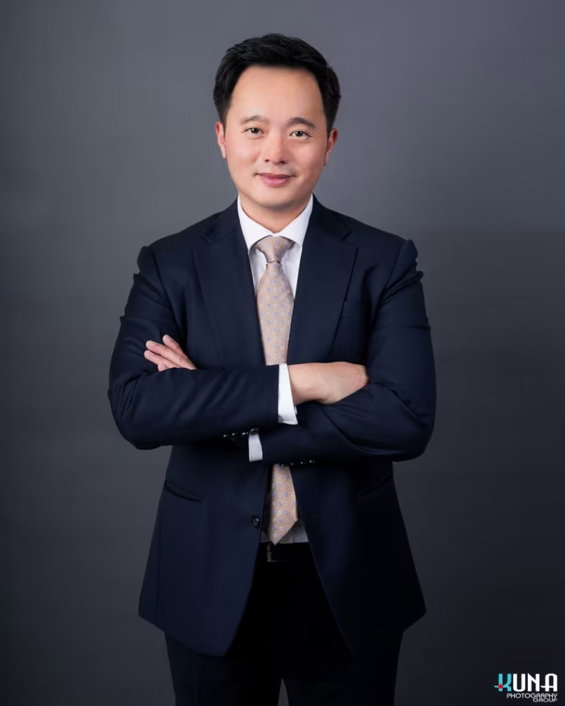 Polished corporate board member headshot of a male TCCBC director in a dark suit and patterned tie in Vancouver British Columbia