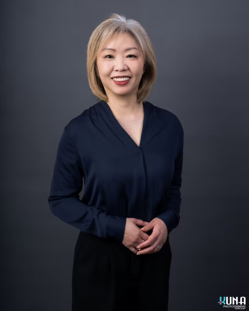 Elegant corporate board member headshot of a female TCCBC executive in a dark blue blouse in Vancouver British Columbia
