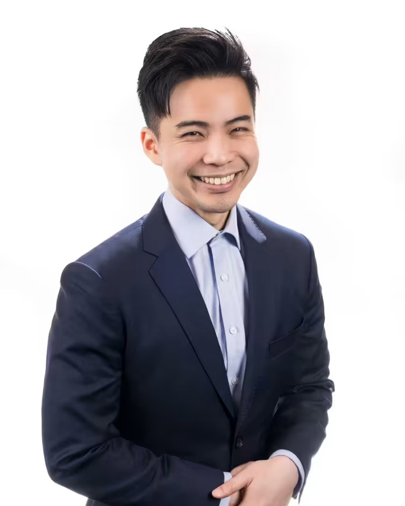 Sam Chung, residential brokerage advisor at VanHaus, laughing naturally during a vancouver mobile headshot studio setup.
