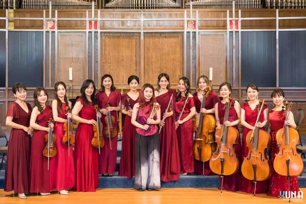 Formosa Music Ensemble group portrait with a guest percussionist, YueYi Liu holding mallets on stage