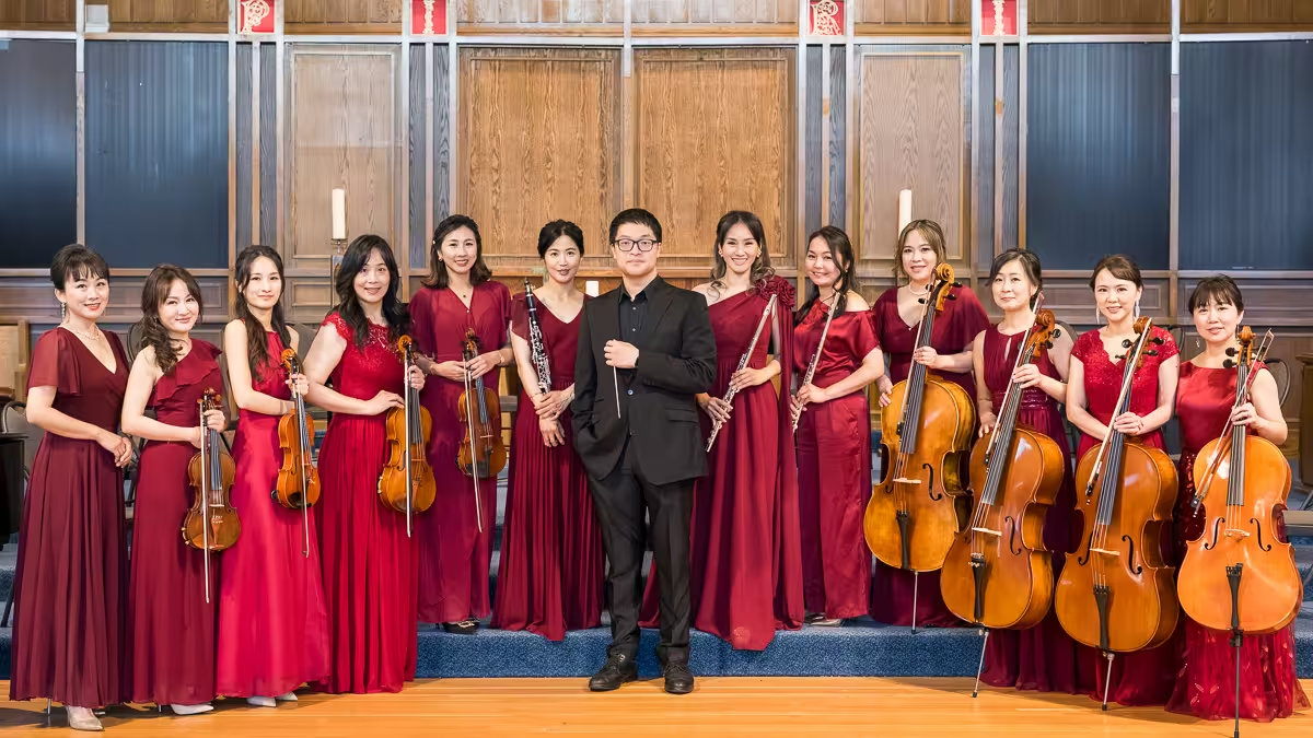 Formosa Music Ensemble members and conductor posing on stage for the annual charity concert in Vancouver