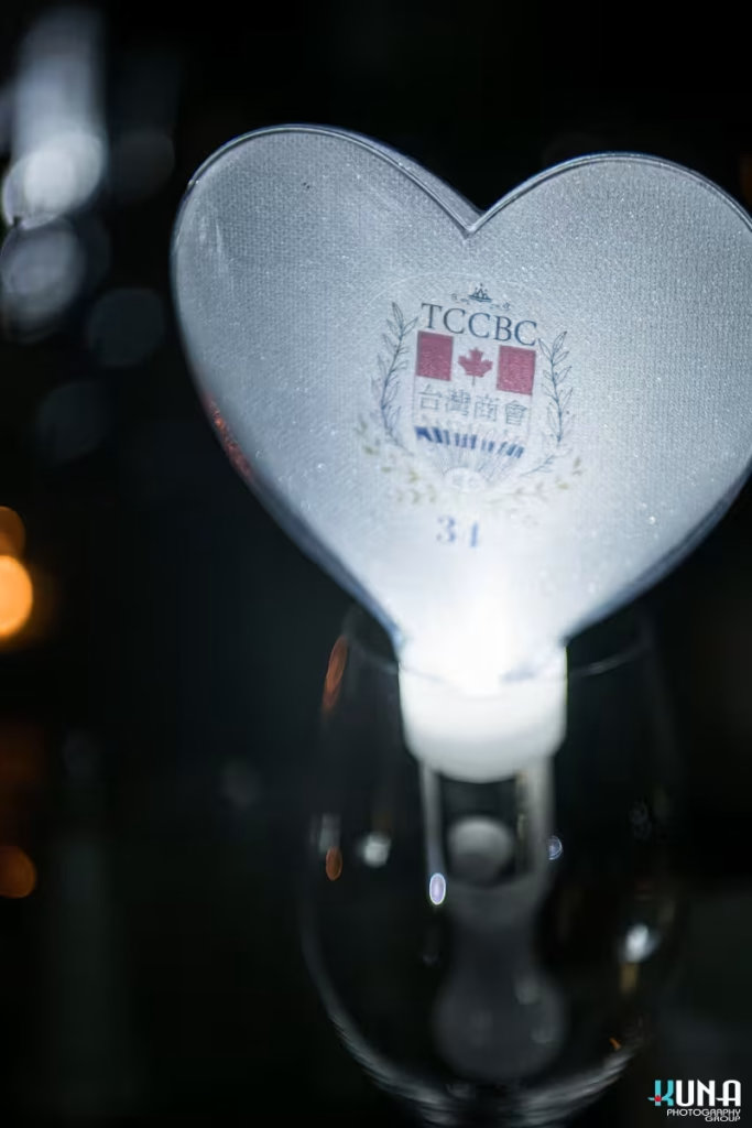 Heart shaped light stick branding photography at Richmond gala Close-up of a heart-shaped light stick featuring the TCCBC 34 logo inside.