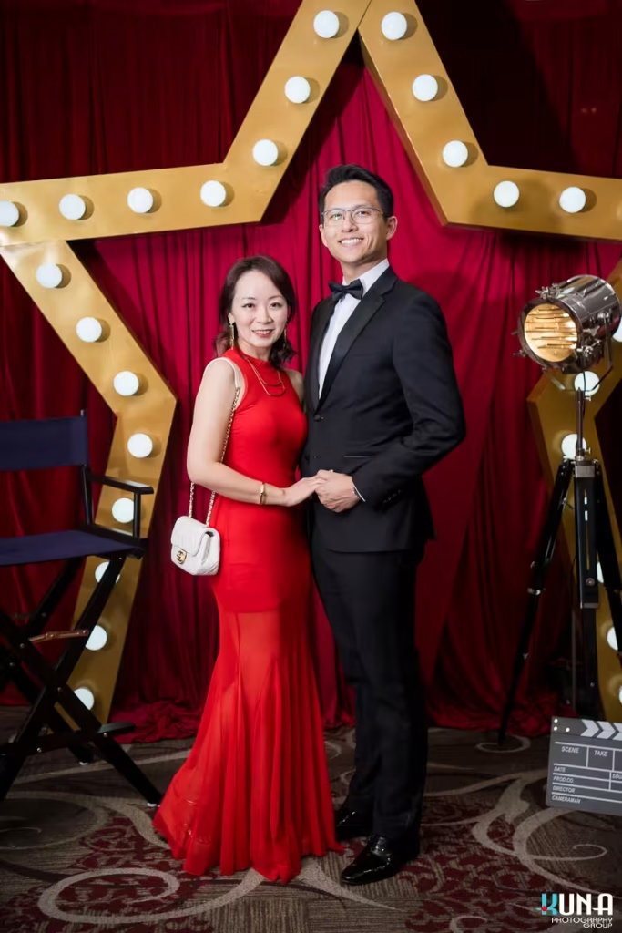 Glamorous couple photo by Vancouver gala photographer at River Rock Theatre A couple elegantly dressed posing in front of a giant illuminated star backdrop at the gala event.