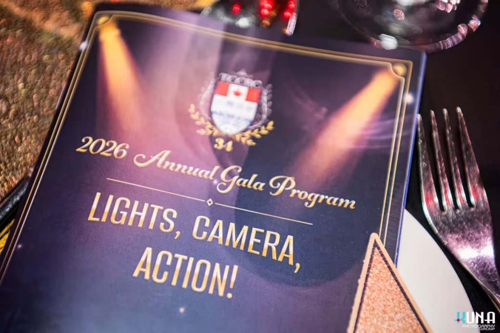 TCCBC Annual Gala program booklet cover design photography The 2026 TCCBC Annual Gala program booklet titled Lights Camera Action on a dining table.