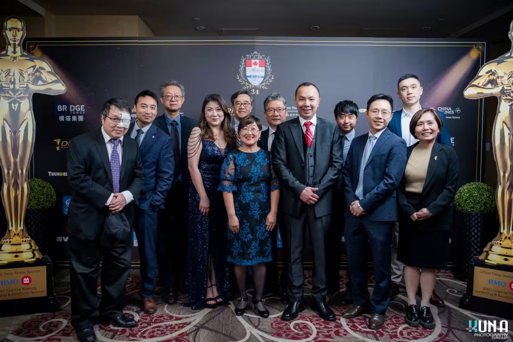 Red carpet group photography at TCCBC Annual Gala in British Columbia Group of VIP guests in formal attire posing by Oscar statues on the red carpet at the Richmond venue.
