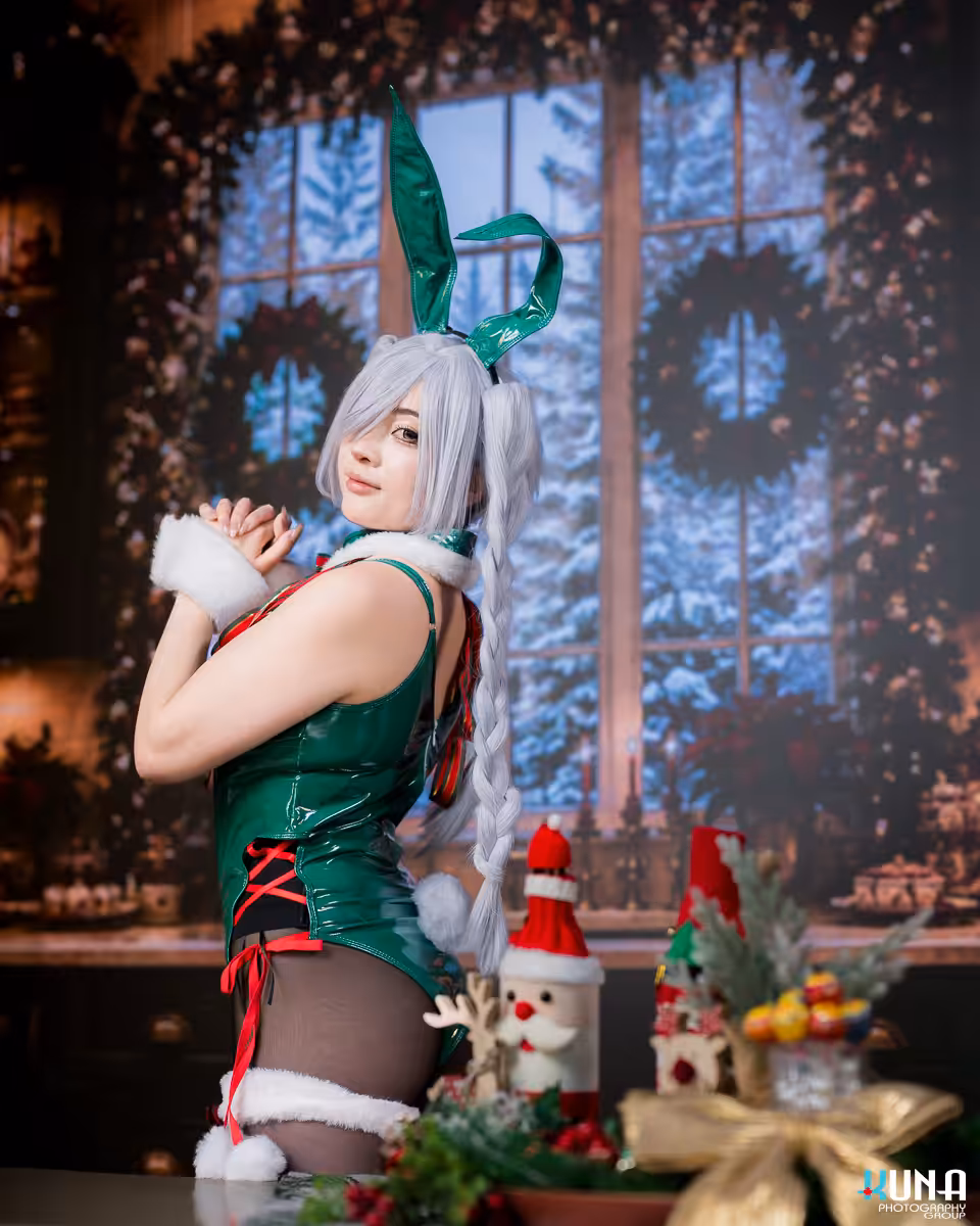 Cosplayer posing next to a festive table with a snowy window scene on the LED screen behind her in Metro Vancouver.